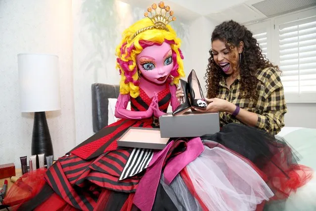 Gooliope, the newest character from Monster High, gifts Jordin Sparks custom Skulette heels made by @DTLACustom and @PalterDeliso at the KIIS-FM's Teen Choice Gifting Suite on Fri., August 14, 2014, in Los Angeles. (Photo by Casey Rodgers/Invision for Mattel/AP Images)