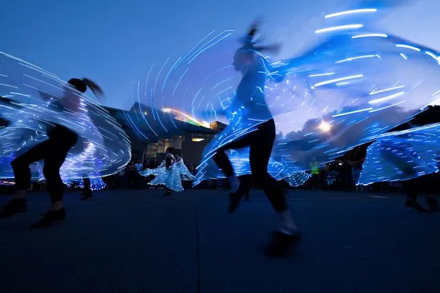 Woman dance wearing lights during the lantern festival, part of the Chinese New Year celebrations, on the waterfront in Wellington on February 14, 2020. With tourist numbers from China down because of the Coronavirus outbreak, fewer Chinese are visiting New Zealand and the Pacific. (Photo by Marty Melville/AFP Photo)