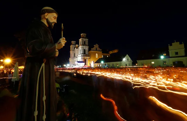 Catholics from Belarus and neighbouring countries carry candles during the annual Icon of the Mother of God procession in the village of Budslav, Belarus July 1, 2016. (Photo by Vasily Fedosenko/Reuters)