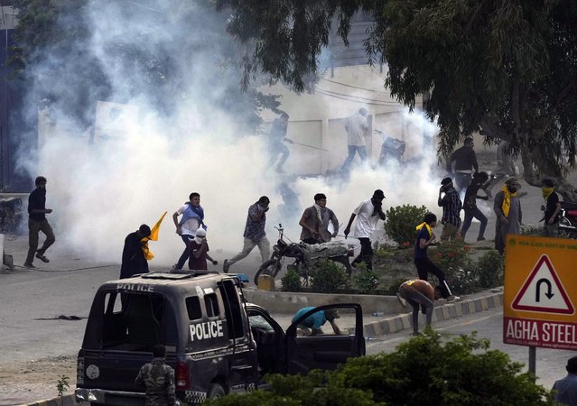 Police fire tear gas to disperse Shiite Muslims during a protest against the killing of Hezbollah leader Hassan Nasrallah, near the U.S. consulate, in Karachi, Pakistan Sunday, September 29, 2024. (Photo by Fareed Khan/AP Photo)