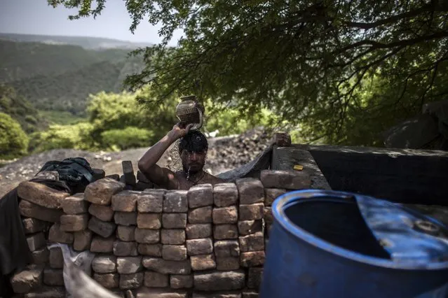 A miner washes after finishing his shift at a coal mine in Choa Saidan Shah, Punjab province, April 29, 2014. (Photo by Sara Farid/Reuters)