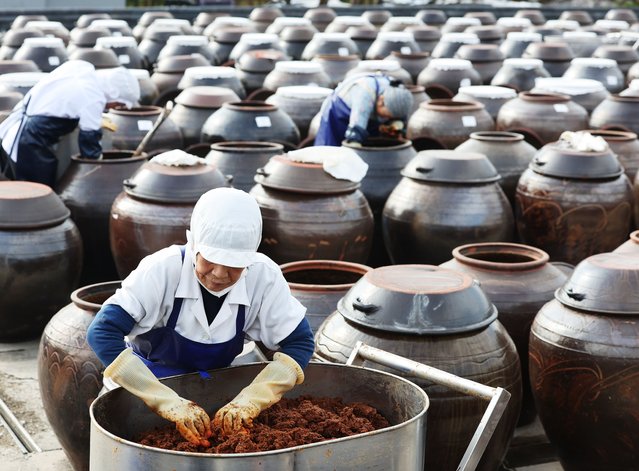 Employees make “jang” at a traditional Korean outdoor farm for “doenjang”, a fermented soybean paste, in Anseong, some 65 kilometers south of Seoul, South Korea, 05 November 2024. Earlier in the day, UNESCO said its deliberative body has categorized “knowledge, beliefs, and practices related to jang-making in the Republic of Korea” as recommended for inscription in its list of intangible cultural heritage. “Jang” is a traditional Korean fermented soybean-based condiment foundational to many Korean dishes. It includes several varieties, such as doenjang, “ganjang” (soy sauce), and “gochujang” (red pepper paste). (Photo by Yonhap/EPA/EFE)