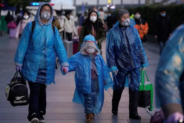 People wear face masks and plastic raincoats as a protection from coronavirus at Shanghai railway station, in Shanghai, China on February 17, 2020. (Photo by Aly Song/Reuters)