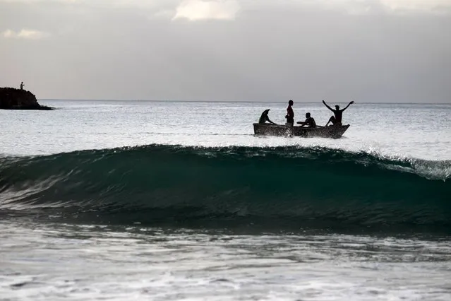 People bring in a boat in Haina, Dominican Republic, August 28, 2015. Tropical Storm Erika threatened Haiti and the Dominican Republic with heavy rain and strong winds on Friday as it swirled across the Caribbean and geared up for a run at South Florida, the U.S. National Hurricane Center said. Due to some likely weakening over mountainous areas, Erika was no longer forecast to make U.S. landfall as a hurricane. (Photo by Ricardo Rojas/Reuters)