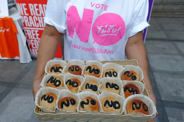 An activist wearing a “Vote No” t-shirt, sells bread with “No” written on it during a campaign against junta-back draft constitution, ahead of the August 7 referendum at Thammasat University in Bangkok, Thailand, July 24, 2016. (Photo by Chaiwat Subprasom/Reuters)