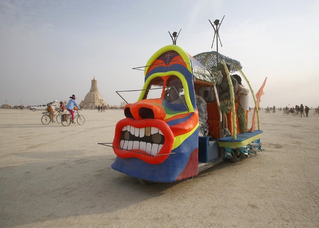 A mutant vehicle drives across the Playa during the Burning Man 2014 “Caravansary” arts and music festival in the Black Rock Desert of Nevada, August 29, 2014. (Photo by Jim Urquhart/Reuters)