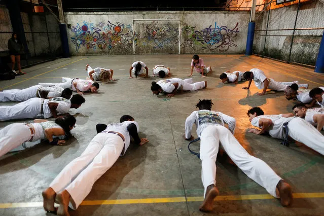 Members of the Acorda Capoeira (Awaken Capoeira) group train at a local school in the Rocinha favela in Rio de Janeiro, Brazil, July 21, 2016. (Photo by Bruno Kelly/Reuters)
