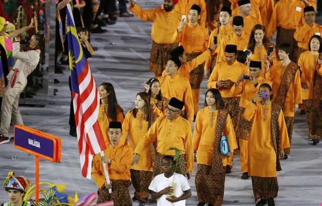 2016 Rio Olympics, Opening ceremony, Maracana, Rio de Janeiro, Brazil on August 5, 2016. Flagbearer Chong Wei Lee (MAS) of Malaysia leads his contingent during the opening ceremony. (Photo by Stoyan Nenov/Reuters)