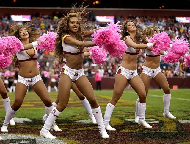 Washington Redskins cheerleaders use pink pom-poms as part of the NFL's campaign to promote breast cancer awareness during the Redskins' 24-17 loss to the Atlanta Falcons in Landover, Maryland, on October 7, 2012. (Photo by Evan Vucci/Associated Press)