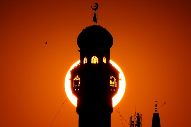 Silhouette of the minaret of Al-Imam Muhsin Mosque is seen in front of the redness of the sky during sunset in Mosul, Iraq on January 29, 2025. (Photo by Ismael Adnan Yaqoob/Anadolu via Getty Images)