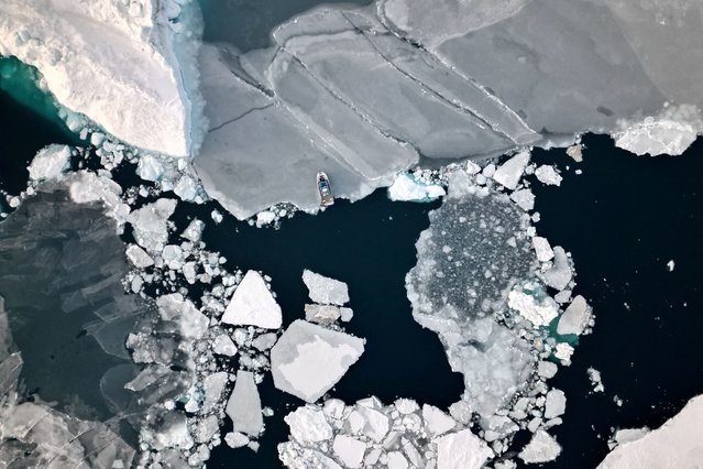 An aerial view shows ice floating in front of Sermitsiaq Island near Nuuk, Greenland, on February 9, 2025. (Photo by Sarah Meyssonnier/Reuters)