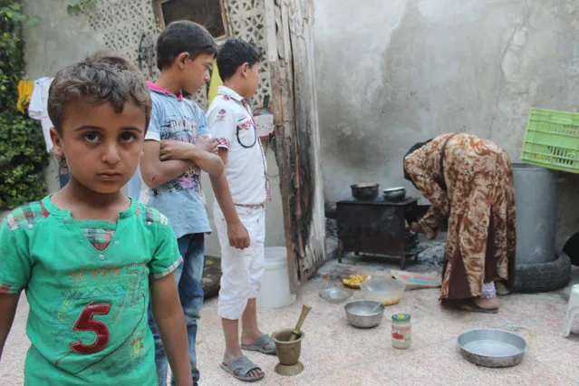 These children have lost their father bombardment and their mother remained miserable and cook them food burning cardboard and plastic in Aleppo, Syria on August 19, 2016. (Photo by Basem Ayoubi/ImagesLive via ZUMA Wire)