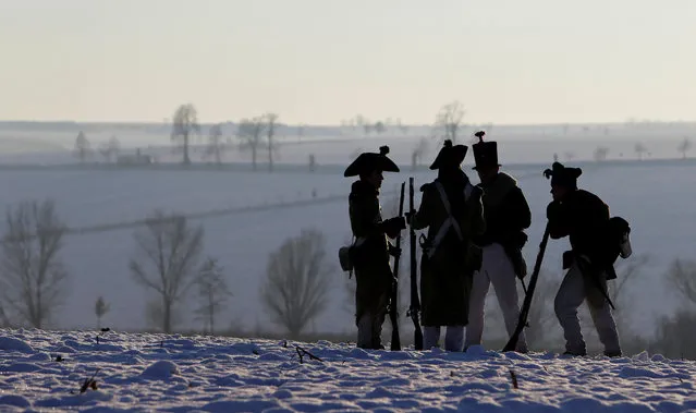 Czech history enthusiasts dressed as soldiers stand guard ahead of a re-enactment of Napoleon's famous battle of Austerlitz, that will take place tomorrow, near the southern Moravian town of Slavkov u Brna, Czech Republic December 1, 2017. (Photo by David W. Cerny/Reuters)