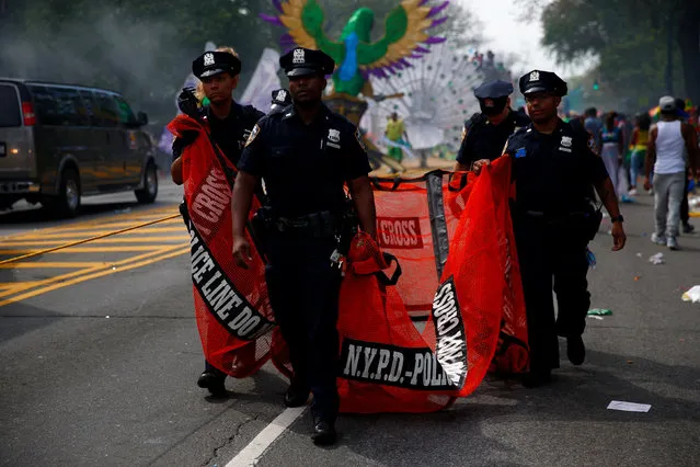 Police carry a barricade during the West Indian Day Parade in the Brooklyn borough of New York September 5, 2016. (Photo by Eric Thayer/Reuters)