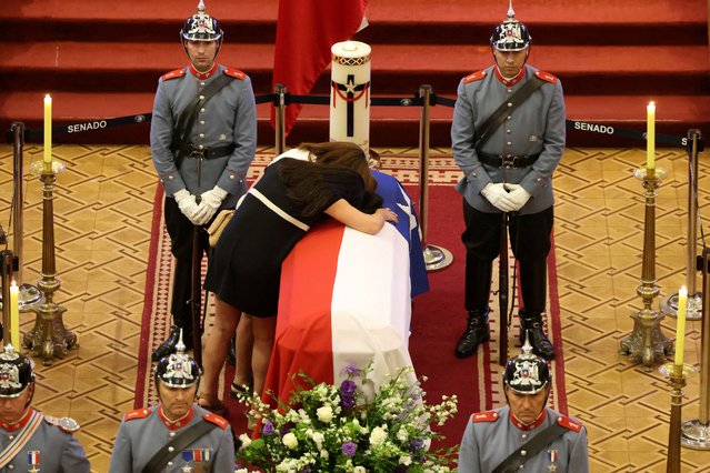 Magdalena and Cecilia Pinera, daughters of Chile's former President Sebastian Pinera, mourn over their father's coffin, at the former National Congress building, in Santiago, Chile, on February 7, 2024. (Photo by Paul Plaza/Senado de la Republica de Chile/Handout via Reuters)