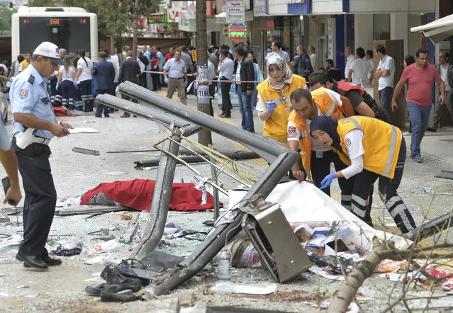 Security personnel attend to  a victim at the scene of a bus accident in Ankara, Turkey, Thursday, October 1, 2015. Over 10 people have been killed after a public bus rammed into a bus stop in the Dikimevi neighborhood of Ankara, according to initial reports. The public bus rammed into people waiting at the bus stop when the driver lost control of the vehicle. (Photo by AP Photo)