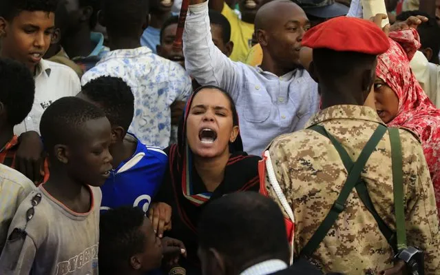 Sudanese protestors chant slogans demanding civilian rule on June 29, 2019 at the end of a rally in Khartoum's twin city of Omdurman in which the chief of the military council delivered a speech. General Abdel Fattah al-Burhan, told a rally in Omdurman, the twin city of Khartoum, that the generals were ready to give up power. “We promise you that we will reach an agreement fast with our brothers in the Alliance for Freedom and Change and other political groups”, he said. “We are ready to cede power today to an elected government that is acceptable to all the people of Sudan”. (Photo by Ashraf Shazly/AFP Photo)