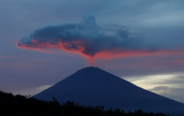 A plume of smoke above Mount Agung volcano is illuminated at sunset as seen from Amed, Karangasem Regency, Bali, Indonesia, November 30, 2017. (Photo by Darren Whiteside/Reuters)
