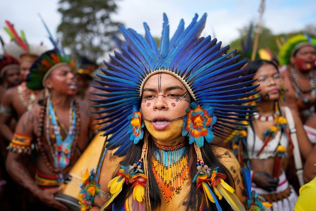 Indigenous people march during the annual Free Earth camp, where they discuss rights, territorial protection and their role in COP30, which will take place for the first time in the Amazon, in Brasilia, Brazil, Tuesday, April 8, 2025. (Photo by Eraldo Peres/AP Photo)