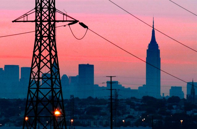 In a Friday, August 15, 2003 file photo, the Empire State Building towers over the skyline of a blackout-darkened New York City just before dawn. (Photo by USA Today)