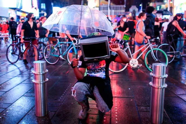 A demonstrator uses a TV case as a facemask during a protest to demand justice for Daniel Prude, on September 3, 2020 in New York City. Protests were planned in New York September 3 over the death of Daniel Prude, a black man that police hooded and forced face down on the road, according to video footage that prompted a probe from the state's attorney general. (Photo by Kena Betancur/AFP Photo)