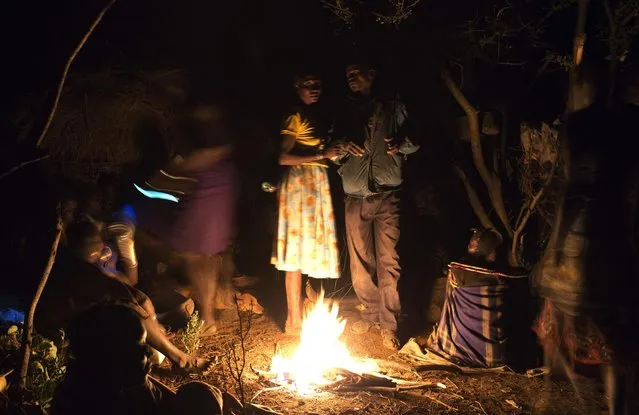 Members of the Pokot tribe gather round a fire before a female circumcision ceremony, about 80 kilometres from the town of Marigat in Baringo County, October 16, 2014. (Photo by Siegfried Modola/Reuters)