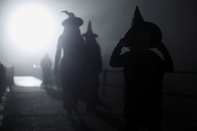 People walk on the street before the opening ceremony of the Witches and Wizards Convention, in the Paranapiacaba village, in Santo Andre, Brazil on May 16, 2025. (Photo by Jean Carniel/Reuters)