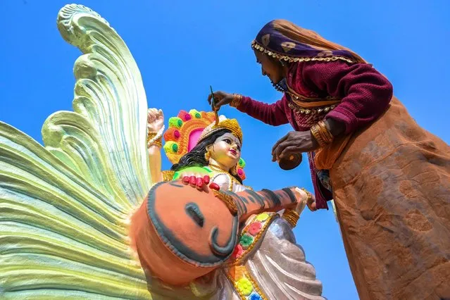 An artist paints an idol of the Hindu goddess Saraswati ahead of the “Basant Panchami” festival, on the outskirts of Amritsar on January 23, 2023. (Photo by Narinder Nanu/AFP Photo)