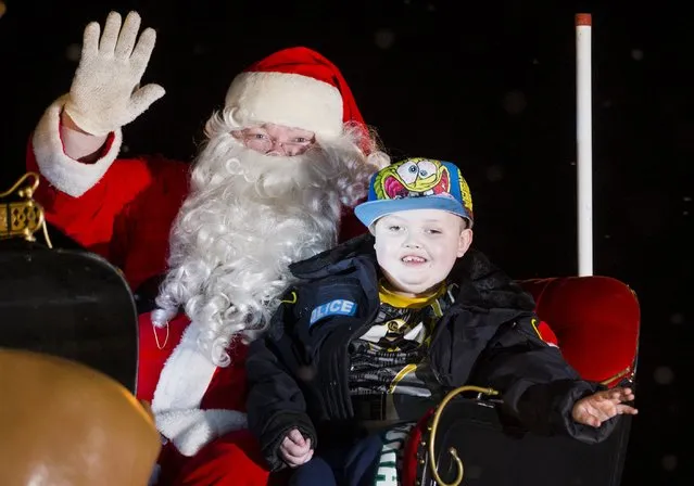 Evan Leversage, who is terminally ill with brain cancer, rides off in the Santa Claus float during a Christmas parade in St. George, Ontario, Canada October 24, 2015. (Photo by Mark Blinch/Reuters)