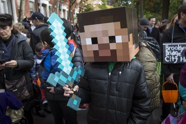 A child dressed as a character from Minecraft takes part in the Children's Halloween day parade at Washington Square Park in the Manhattan borough of New York October 31, 2015. (Photo by Carlo Allegri/Reuters)