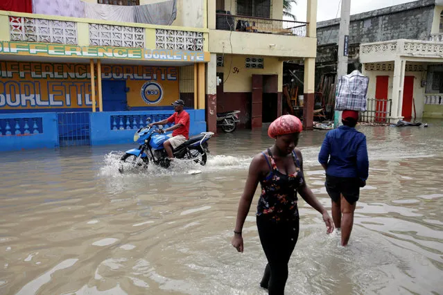 People walk in a flooded area after Hurricane Matthew in Les Cayes, Haiti, October 5, 2016. (Photo by Andres Martinez Casares/Reuters)