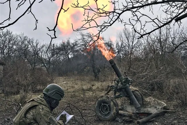 Volunteer soldiers fire towards Russian positions close to Bakhmut, Donetsk region, Ukraine, Wednesday, March 8, 2023. (Photo by Libkos/AP Photo)
