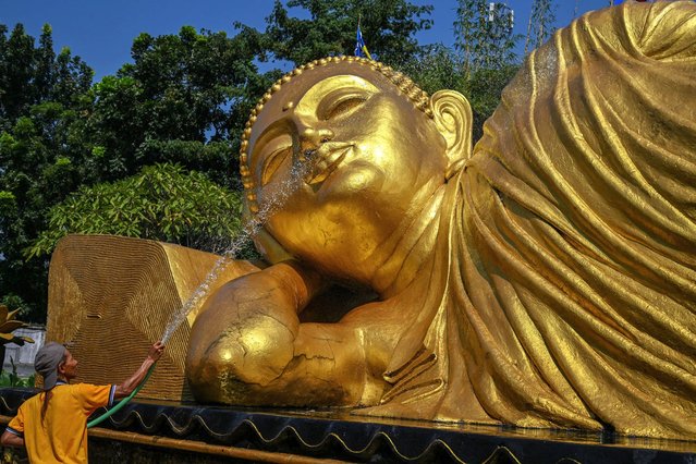 Workers clean a Buddha statue at the Maha Vihara Mojopahit temple in Mojokerto, Indonesia on May 15, 2024 ahead of the Vesak festival which commemorates the birth, enlightenment and death of Buddha. (Photo by Juni Kriswanto/AFP Photo)