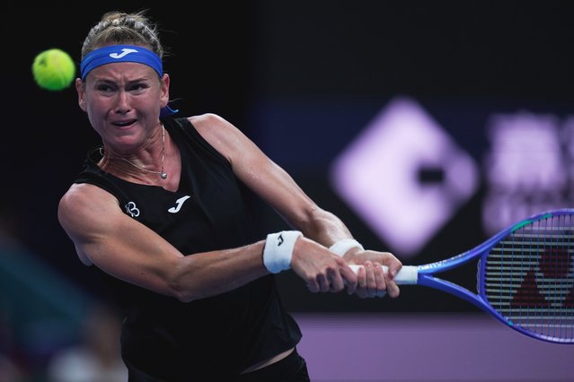 Marie Bouzkova of the Czech Republic plays a shot against Jasmine Paolini of Italy during the women's singles match of the China Open tennis tournament in Beijing, Tuesday, September 30, 2025. (Photo by Mahesh Kumar A./AP Photo)