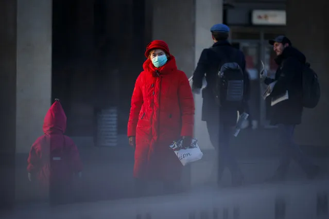 A woman wearing a face mask to help curb the spread of the coronavirus walks into the underpass under the street during sunset in Moscow, Russia, Wednesday, December 2, 2020. Russia has registered a record number of coronavirus deaths for a second straight day. Currently, there is a country-wide mask mandate and mostly mild restrictions that vary from region to region. (Photo by Alexander Zemlianichenko/AP Photo)