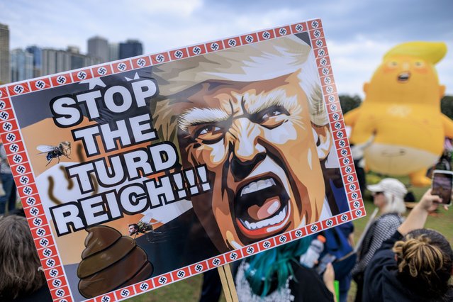 A placard depicting US President Donald J Trump and reading “Stop the t*rd Reich” is displayed during the “No Kings” protest in Downtown Chicago, Illinois, USA, 18 October 2025. The protest is part of a nationwide “No Kings” day of action, opposing what organizers see as authoritarian overreach and threats to democracy under US President Donald J. Trump. (Photo by Cristobal Herrera-Ulashkevich/EPA)