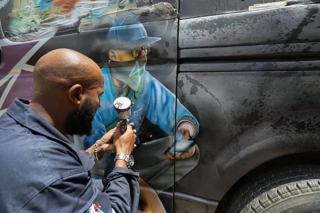 A graffiti designer Mohamed Kartarchand popularly known as “Moha Grafix” paints a graffiti on a van to be used as a public service vehicle at his garage in Nairobi, Kenya, 21 March 2018. (Photo by Daniel Irungu/EPA/EFE)
