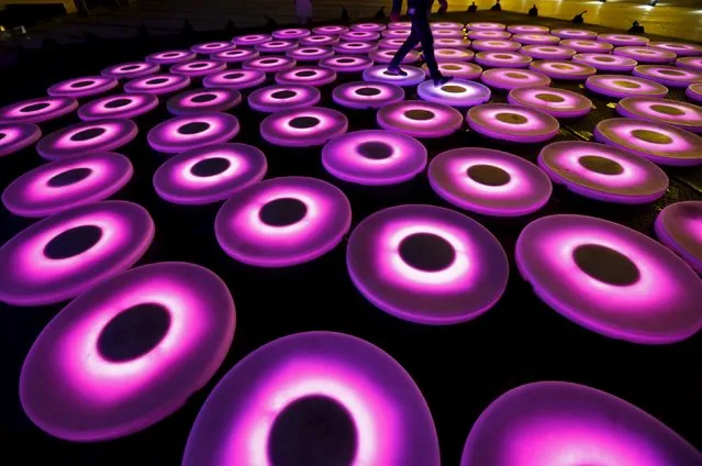A man walks over a light installation called "The Pool" by Jen Lewin of the U.S. during the Istanbul Light Festival at Zorlu center in Istanbul, Turkey, November 18, 2015. (Photo by Murad Sezer/Reuters)