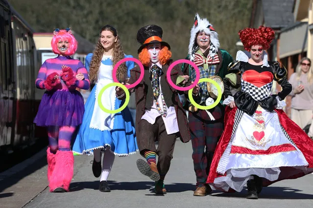 Picture shows members of Pure Entertainment, dressed as characters from Alice in Wonderland, on the platform at Bolton Abbey station in North Yorkshire on April 7, 2023. The heritage line runs for four miles, and was part of the former Skipton to Ilkley line which was closed down by British Railways in 1965. (Photo by Lorne Campbell/Guzelian)
