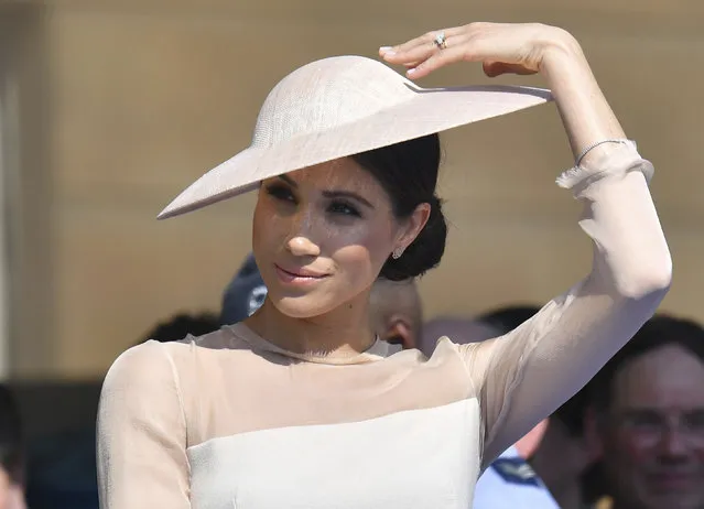 Meghan, the Duchess of Sussex gestures as she attends a garden party at Buckingham Palace in London, Tuesday, May 22, 2018, her first royal engagement a since her wedding to Prince Harry on Saturday. The event is part of the celebrations to mark the 70th birthday of Prince Charles. (Photo by Dominic Lipinski/Pool Photo via AP Photo)