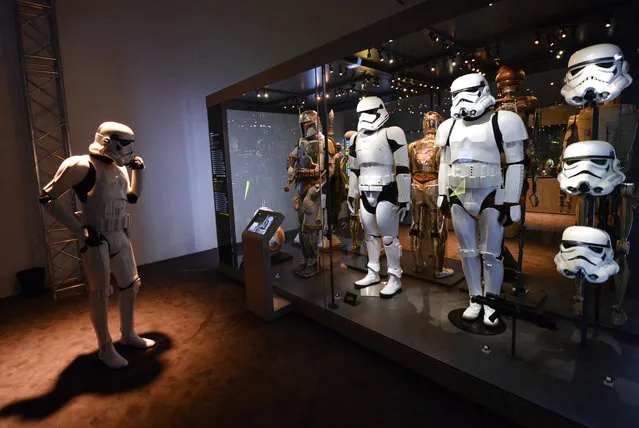 A member of the “501st Legion” – Star Wars fan club in a Stormtrooper-costume looks at stormtrooper costumes at the 'Star Wars Identities' exhibition in the Museum fuer angewandte Kunst in Vienna, Austria, December 17, 2015. (Photo by Hans Klaus Techt/EPA)