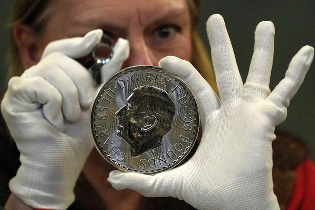 A warden looks through a magnifyer to check a 500 Pound coin during the “Trial of the Pyx”,' a ceremony that dates to the 12th Century in which coins are weighed in order to make certain they are up to standard, at the Goldsmiths' Hall in London, Tuesday, February 11, 2025. (Photo by Frank Augstein/AP Photo)