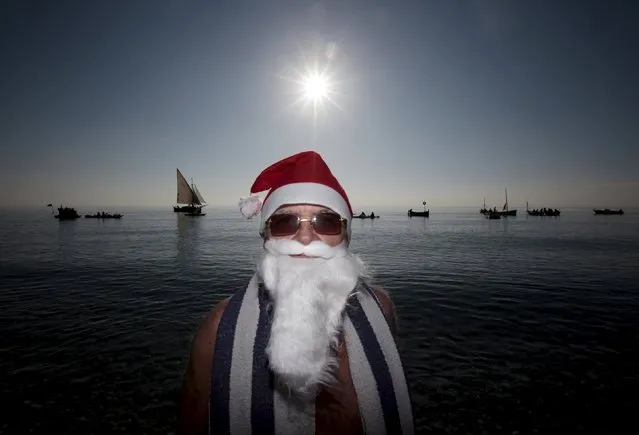 A man dressed as a Santa Claus takes part in the traditional Christmas bath during an unusually warm winter day in Nice, southeastern France, December 20, 2015. (Photo by Eric Gaillard/Reuters)