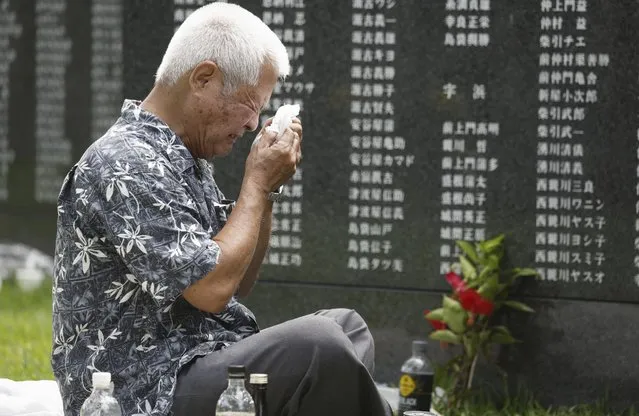 A man cries in front of the Cornerstone of Peace monument walls on which the names of all those who lost their lives during the Battle of Okinawa, at the Peace Memorial Park in Itoman, Okinawa prefecture, southern Japan Friday, June 23, 2023. Japan marked the Battle of Okinawa, one of the bloodiest battles of World War II fought on the southern Japanese island, which ended 78 years ago. (Photo by Kyodo News via AP Photo)