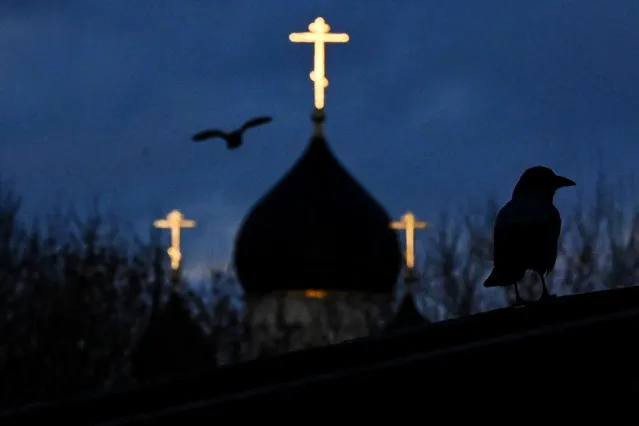 A bird flies in front of a church at sunset on the outskirts of Moscow on March 3, 2021. (Photo by Kirill Kudryavtsev/AFP Photo)
