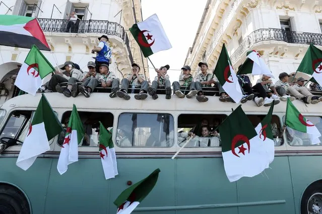 Algerian scouts wave national flags as they take part in a parade one day before the country's Independence Day in Algiers, Algeria, 04 July 2023. Algeria celebrates on 05 July the 61st anniversary of its Independence from France. (Photo by Mohamed Messara/EPA)