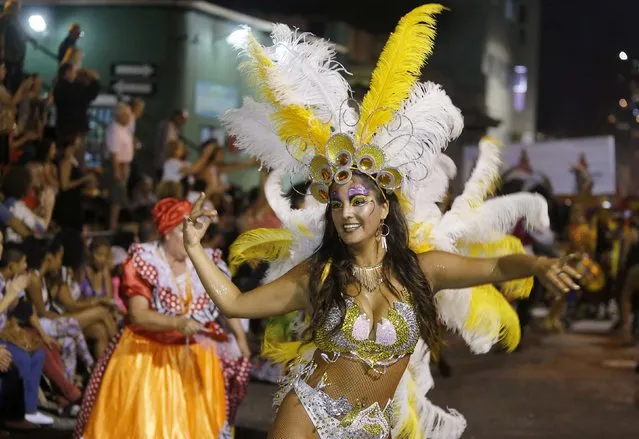 A member of a comparsa, a Uruguayan carnival group, dances during the Llamadas parade in Montevideo February 5, 2015. (Photo by Andres Stapff/Reuters)