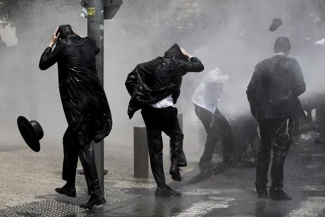 Police use   water canon to disperse an  Ultra-Orthodox Jewish demonstrators that   block the Light Rail track during a protest against army recruitment in central Jerusalem, Israel, 02 August  2018. The Ultra-Orthodox community in Israel is holding ongoing protests against army recruitment. (Photo by Abir Sultan/EPA/EFE)