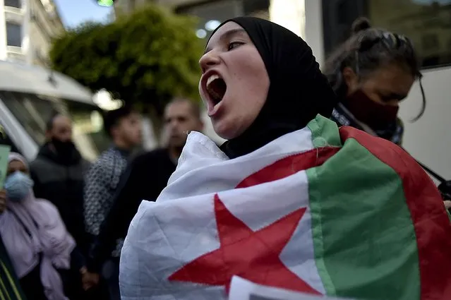 Algerians shout slogans during an anti-government demonstration in the capital Algiers on March 23, 2021. (Photo by Ryad Kramdi/AFP Photo)