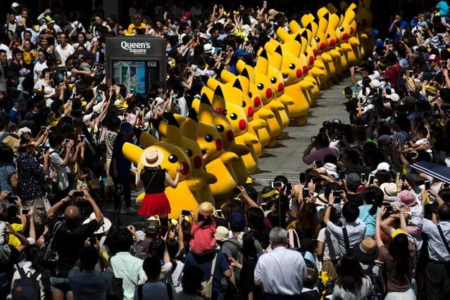 Performers dressed as Pikachu, a character from Pokemon series game titles, march during the Pikachu Outbreak event hosted by The Pokemon Co. on August 10, 2018 in Yokohama, Kanagawa, Japan. A total of 1, 500 Pikachus appear at the city's landmarks in the Minato Mirai area aiming to attract visitors and tourists to the city. The event will be held through until August 16. (Photo by Tomohiro Ohsumi/Getty Images)